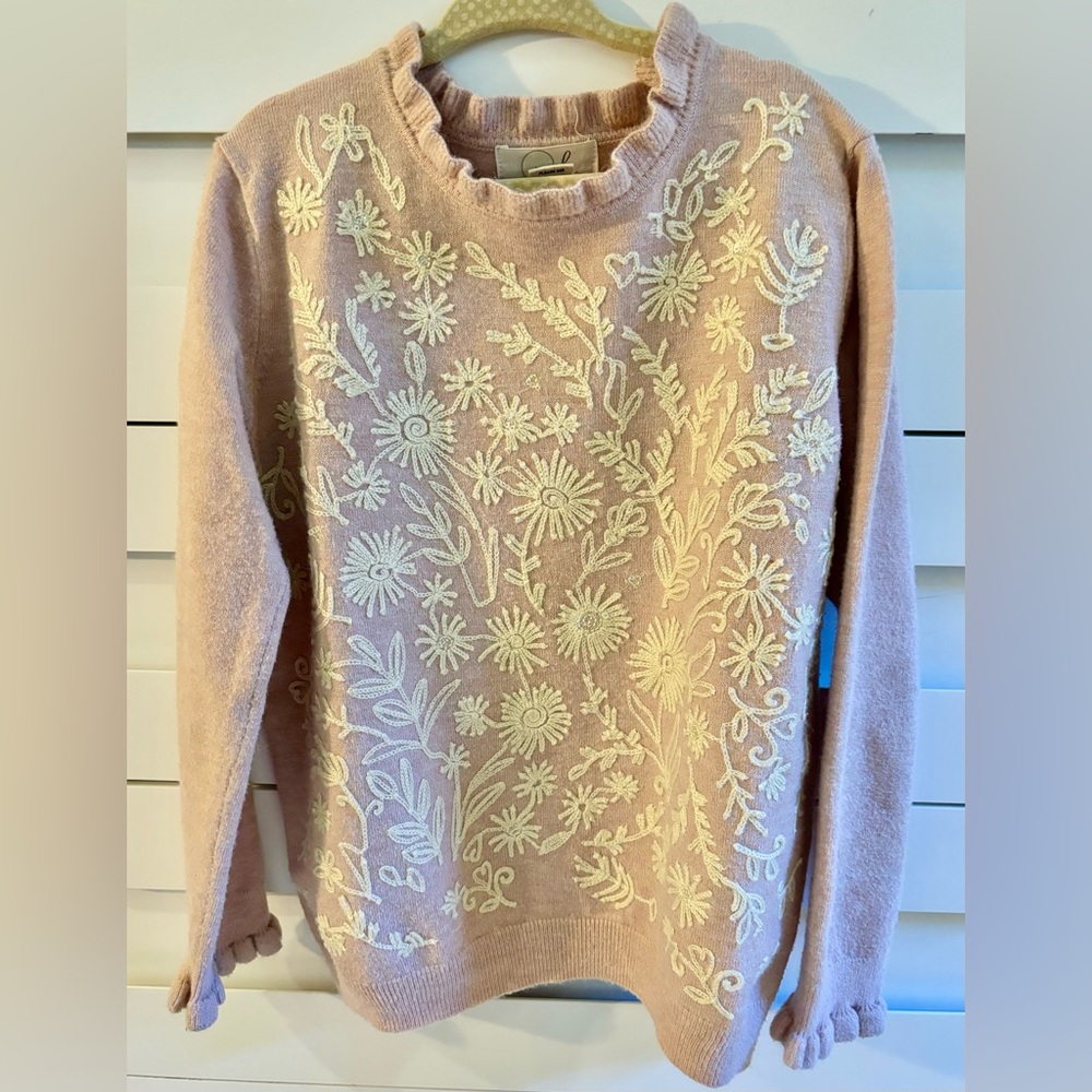 Dusty rose pink sweater with embroidery and sequin details.